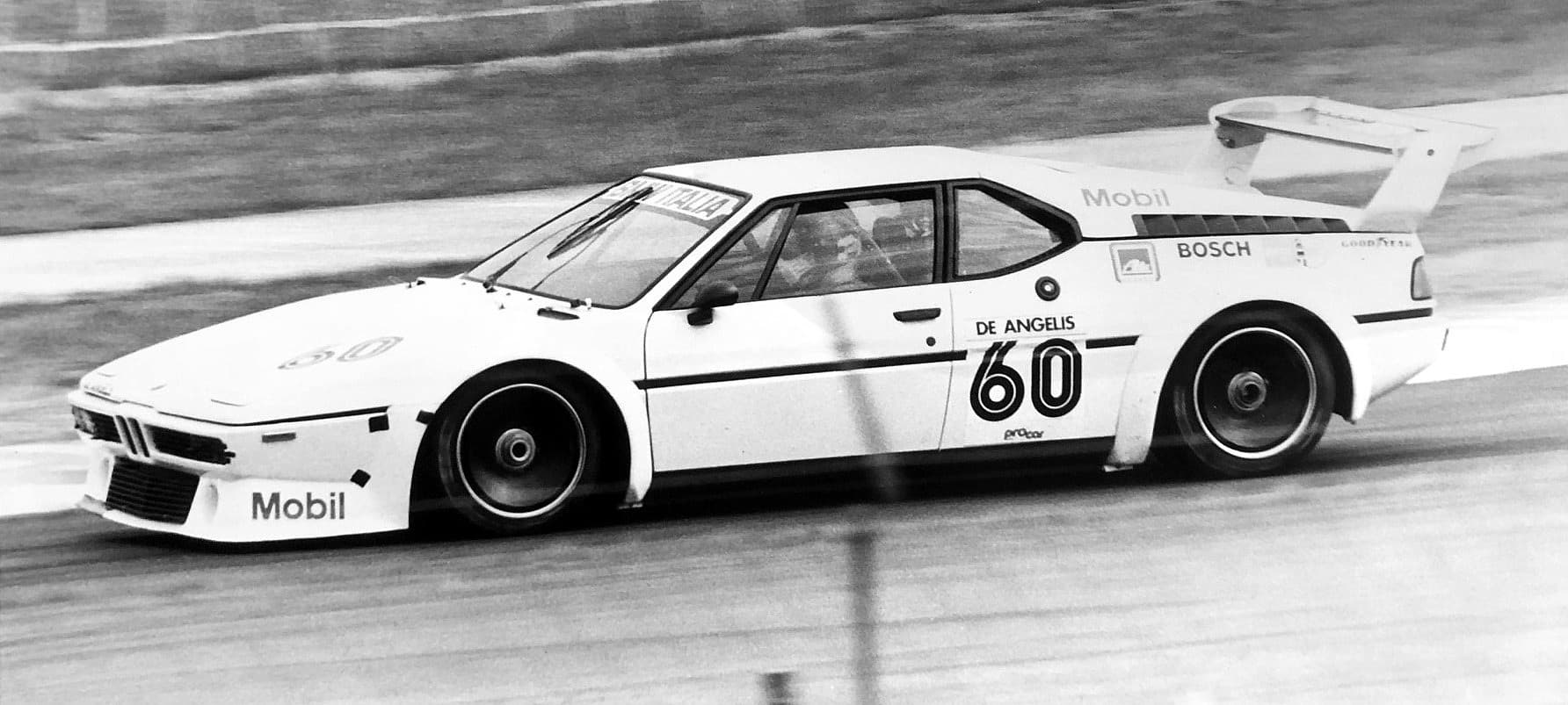 A black and white photograph of a Procar, number 60, panned at Silverstone, with the driver visible through the side window.